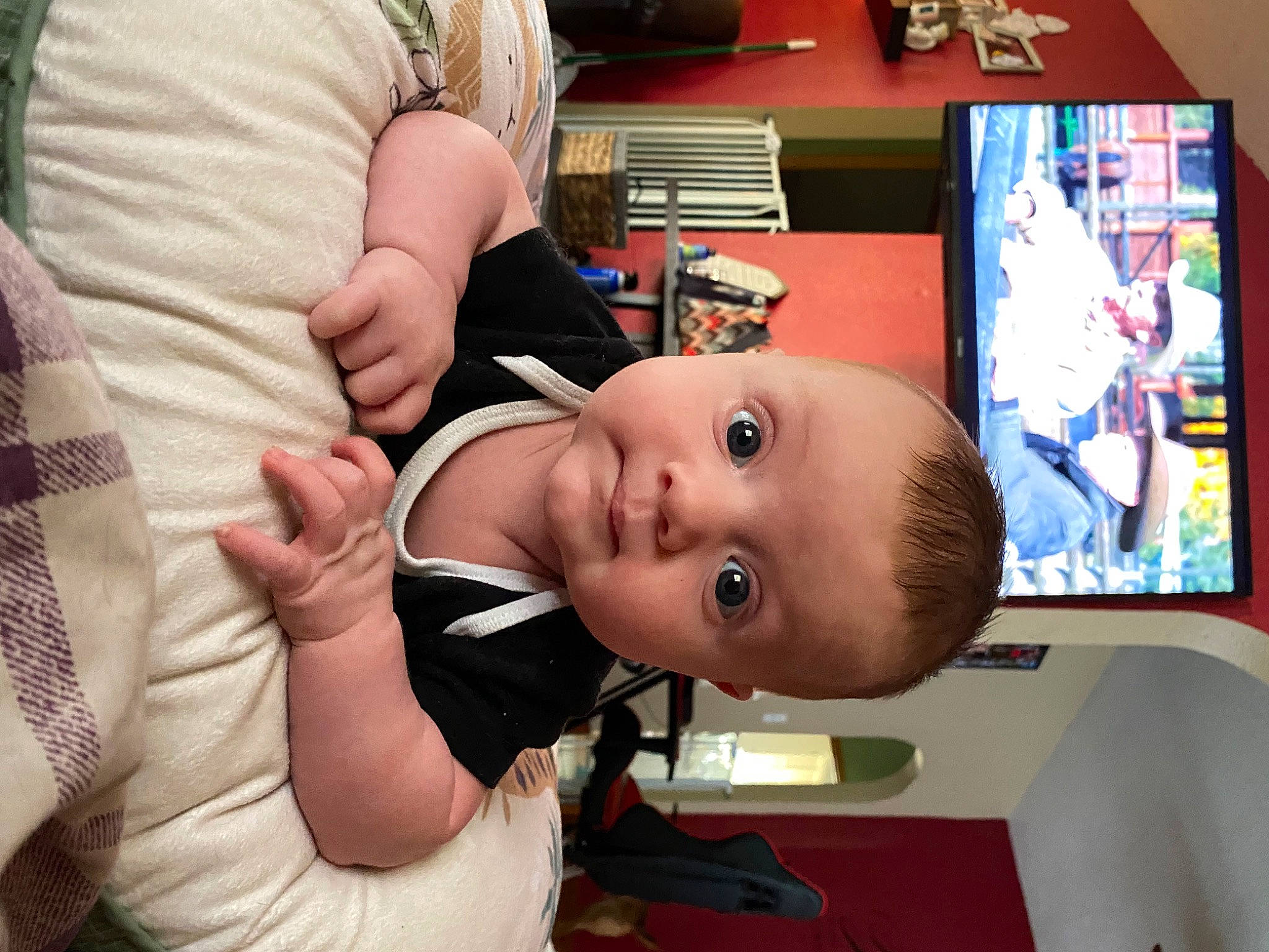 Baylor is registered to the contest to win money with this photo: art, baby, baby_products, baby_toddler_clothing, cheek, child, comfort, display_device, finger, fun, happy, nail, person, play, room, sitting, smile, thumb, toddler, visual_arts