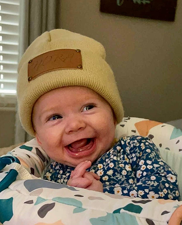 Nora Jolean joined the competition — help win amazing prizes! baby, baby_laughing, baby_toddler_clothing, cap, cheek, child, comfort, face, facial_expression, fun, happy, headgear, headwear, helmet, outerwear, person, skin, smile, textile, toddler