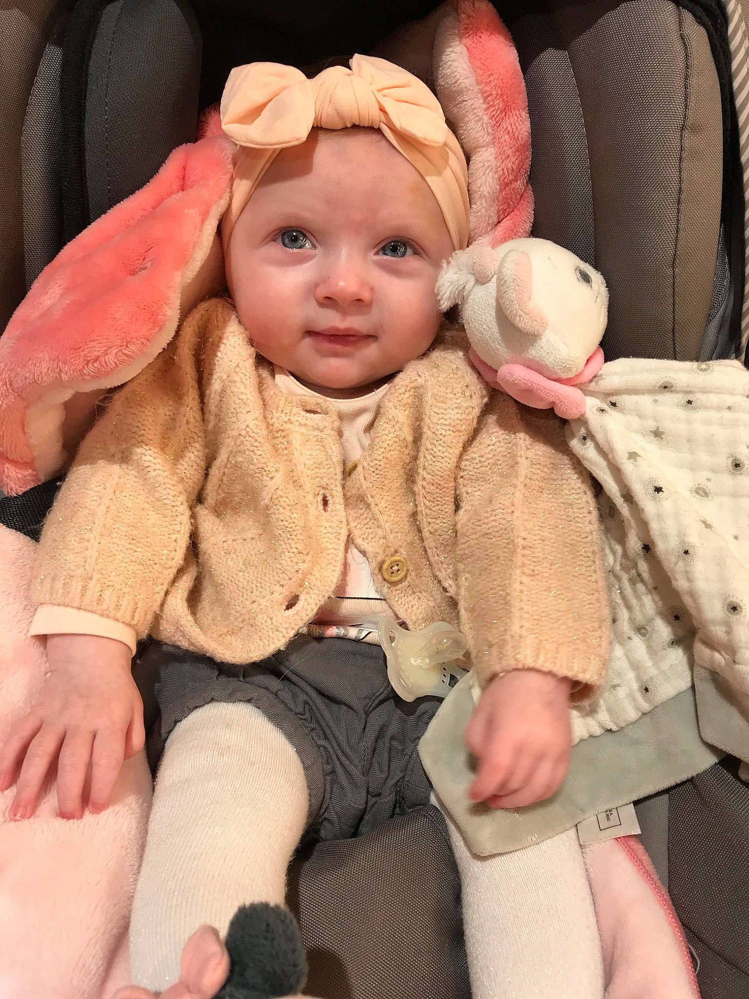 Layanna participe au concours pour gagner de l'argent avec cette photo : baby, baby_in_car_seat, cheek, child, ear, fawn, headwear, person, pink, sitting, skin, toddler