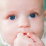 Axton is registered to the contest to win money with this photo: baby, close_up, face, blue_eyes, fingers, infant, cute, skin, portrait, child, expression, hand, young, soft_focus, innocent, sucking, person, head, mouth, adorable
