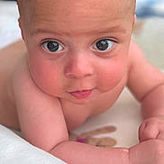 Aaron is registered to the contest to win money with this photo: baby, infant, face, eyes, skin, arm, lying_down, closeup, portrait, cute, child, young, expression, background_blur, natural_light, indoors, soft_texture, skin_tone, head, curious