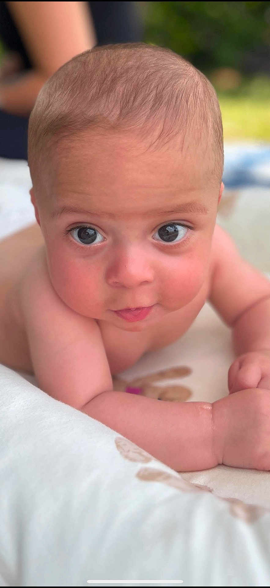Aaron is registered to the contest to win money with this photo: baby, infant, face, eyes, skin, arm, lying_down, closeup, portrait, cute, child, young, expression, background_blur, natural_light, indoors, soft_texture, skin_tone, head, curious