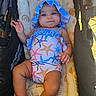 Sky joined the competition — help win amazing prizes! baby, child, stroller, swimsuit, bonnet, starfish_pattern, infant, cushion, sunlight, outdoor, happy, cute, smiling, hand, legs, fabric, seat, blanket, summer, relaxing