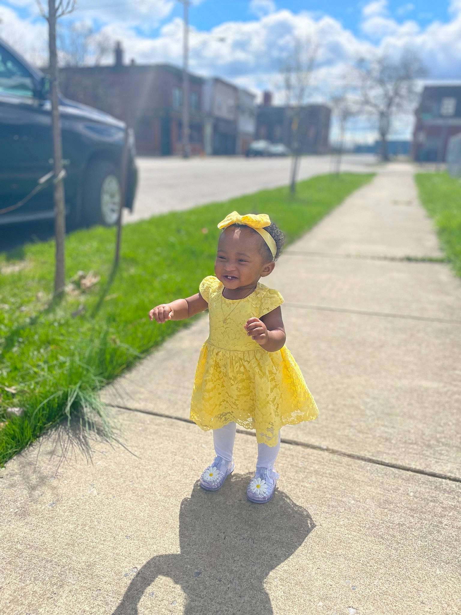Dream is registered to the contest to win money with this photo: asphalt, car, cloud, footwear, fun, grass, hat, infrastructure, leisure, person, plant, road, road_surface, sidewalk, sky, summer, sun_hat, tire, toddler, tree