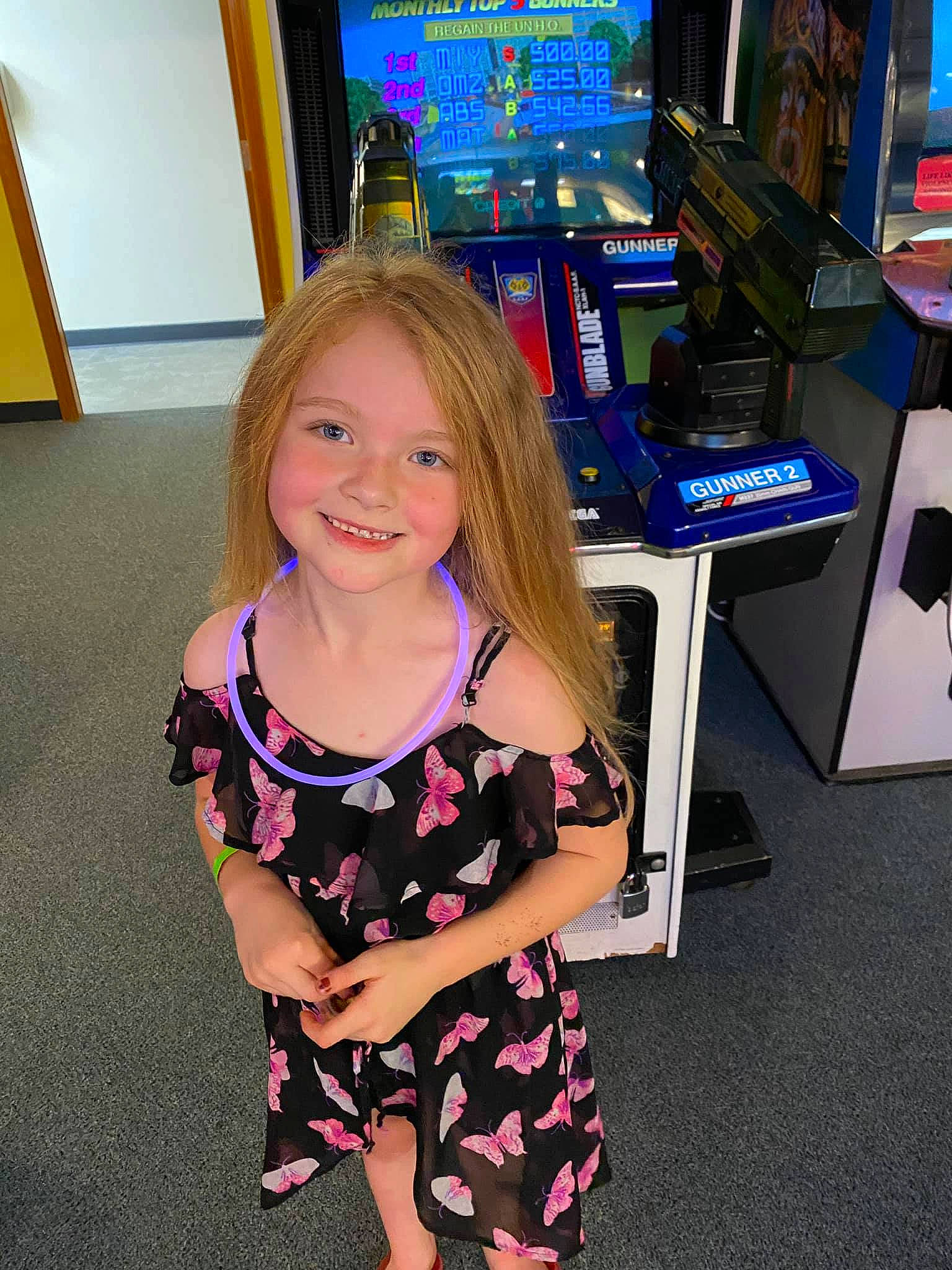 Macy joined the competition — help win amazing prizes! arcade_game, blond, chair, child, electric_blue, event, flooring, fun, gamer, human_leg, indoor_games_and_sports, joy, leisure, machine, person, recreation, recreation_room, smile, table, television_set