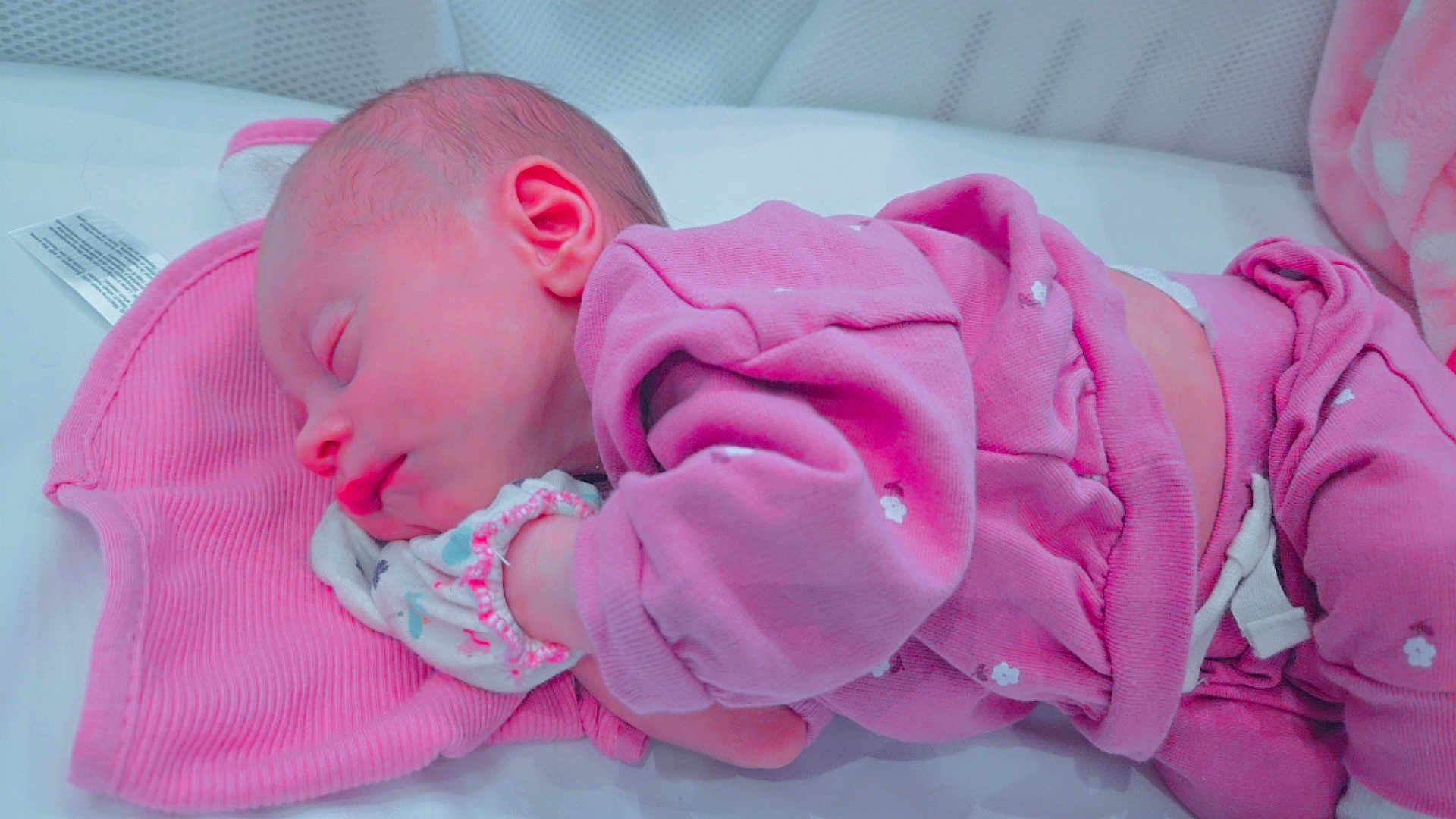 Ivy is registered to the contest to win money with this photo: newborn, baby, sleeping, pink_clothing, pajamas, infant, soft_texture, resting, cute, peaceful, child, face, hand, blanket, indoors, cozy, toddler, portrait, closeup, sleep