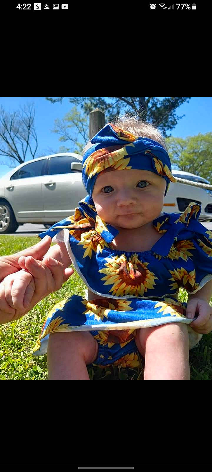 Reighlynn is registered to the contest to win money with this photo: automotive_exterior, bumper, cap, car, electric_blue, eyewear, finger, grass, happy, hat, headwear, leisure, person, plant, recreation, sky, tire, toddler, tree, vehicle