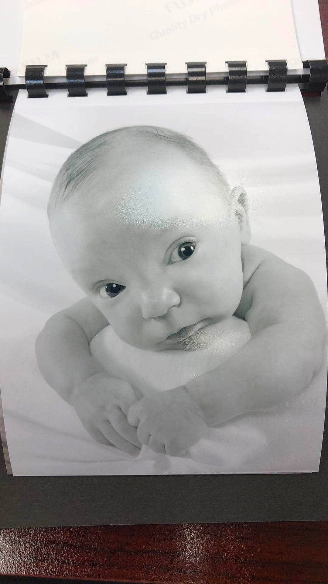 Lee is registered to the contest to win money with this photo: art, baby, black_and_white, cheek, child, drawing, face, head, person, photograph, photographic_paper, photography, picture_frame, portrait, room, stock_photography, toddler