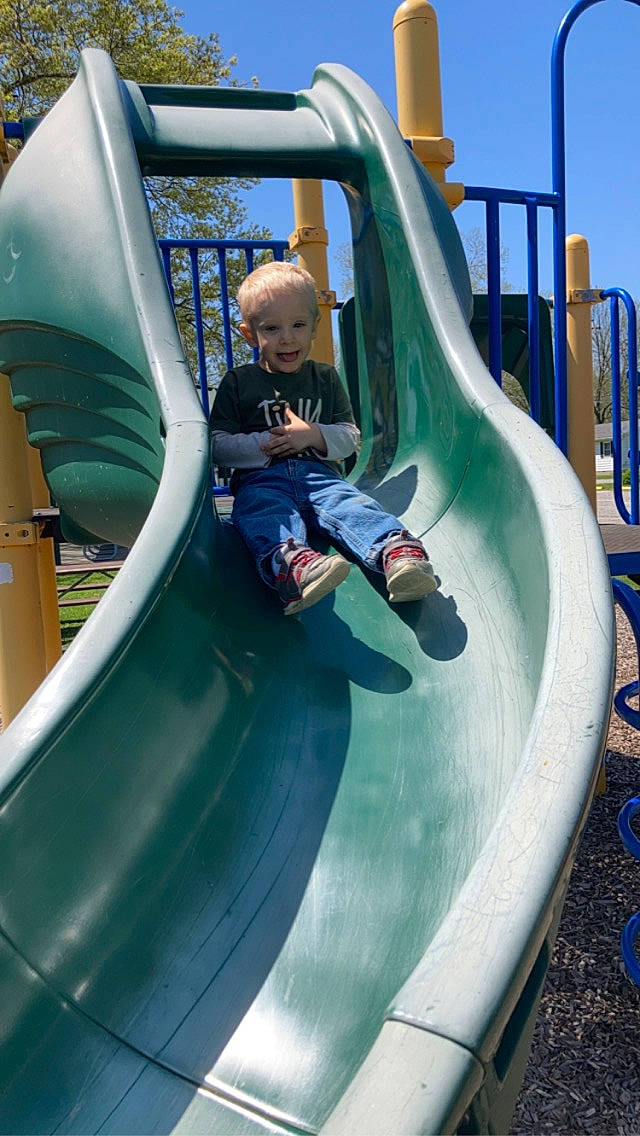Decklyn is registered to the contest to win money with this photo: aqua, blue, child, chute, city, comfort, fun, green, leisure, outdoor_play_equipment, outdoor_recreation, person, play, playground, playground_slide, recreation, sky, smile, snapshot, stairs