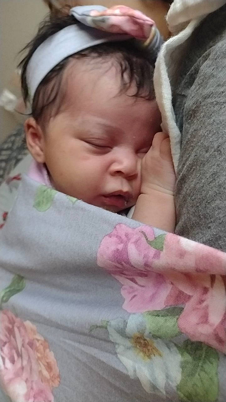 Naomi joined the competition — help win amazing prizes! baby, baby_toddler_clothing, cheek, chin, comfort, eyelash, face, facial_expression, finger, gesture, grass, happy, linens, lip, nose, person, pink, skin, textile, toddler