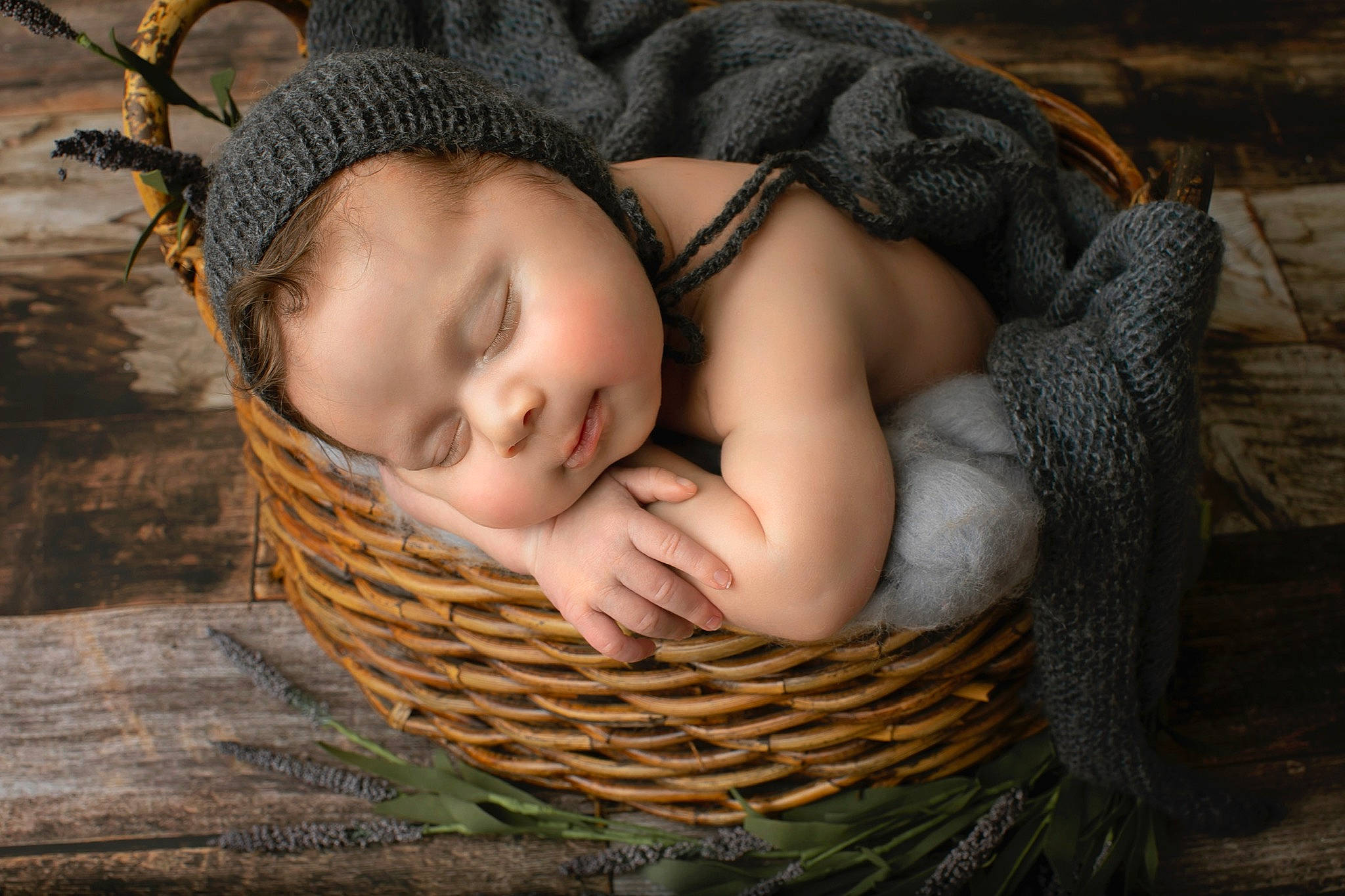 Jovanni is registered to the contest to win money with this photo: baby, baby_toddler_clothing, basket, child, close_up, comfort, facial_expression, fashion_accessory, flash_photography, grass, happy, headgear, knit_cap, people_in_nature, person, sitting, skin, toddler, wood, wool