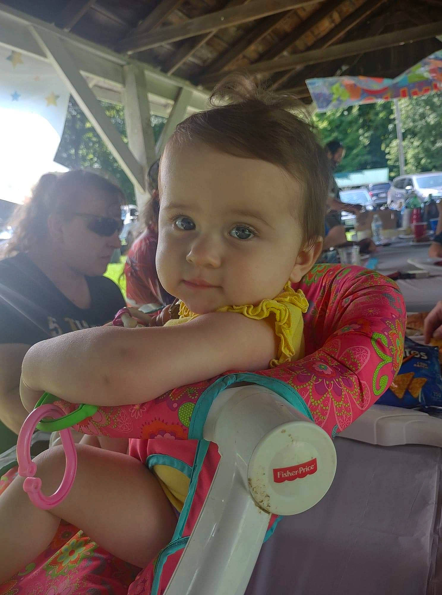 Harper is registered to the contest to win money with this photo: arm, baby, child, event, finger, fun, happy, junk_food, leisure, person, play, product, recreation, sitting, skin, toddler, vacation