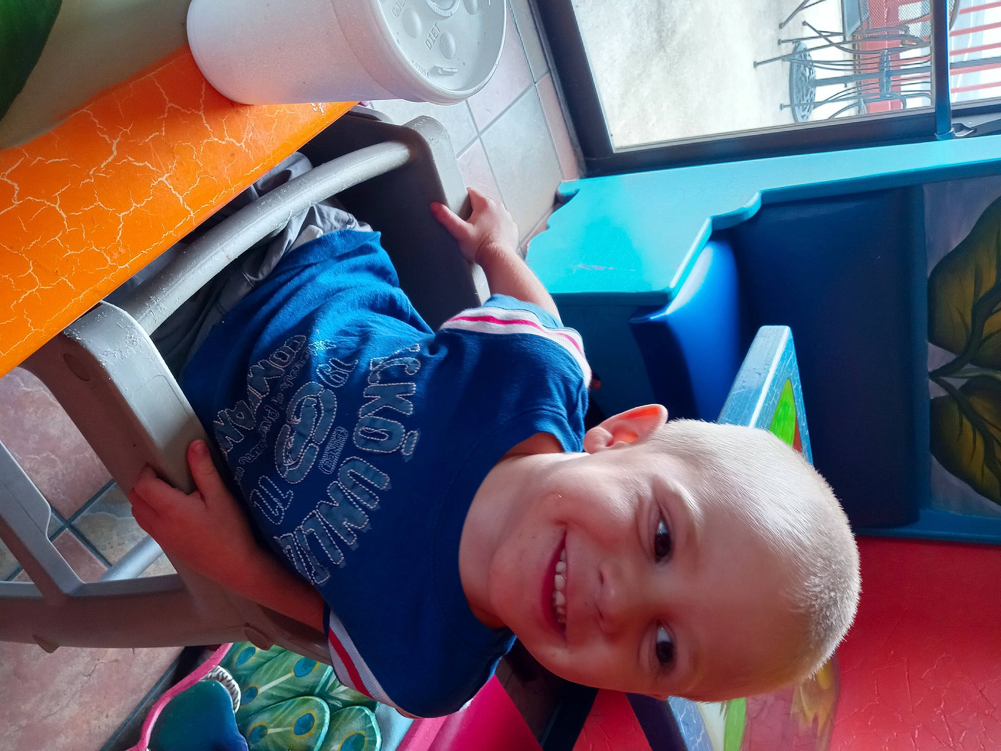 Allen Jr is registered to the contest to win money with this photo: automotive_design, baby, child, comfort, electric_blue, fun, happy, hat, human_leg, joy, leisure, orange, person, product, recreation, smile, summer, t_shirt, thigh, toddler