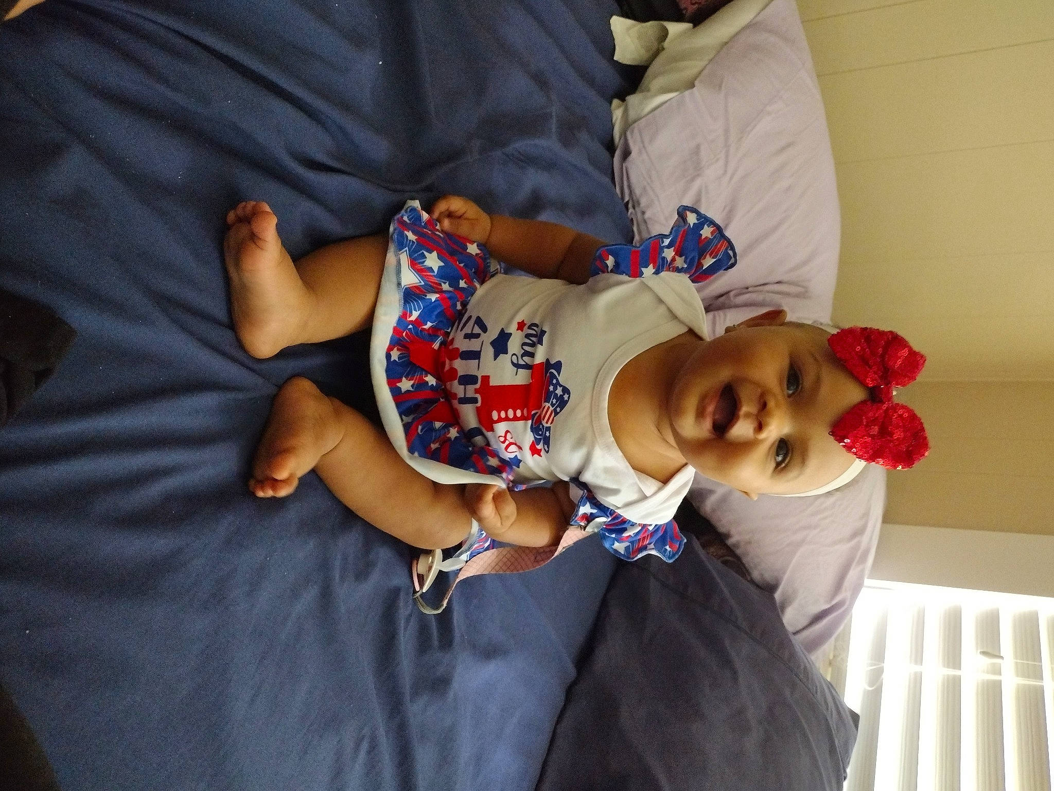 Khalessiah is registered to the contest to win money with this photo: baby_toddler_clothing, child, comfort, elbow, event, fun, happy, hat, headwear, human_leg, joint, lap, linens, person, sitting, sleeve, smile, t_shirt, textile, thigh