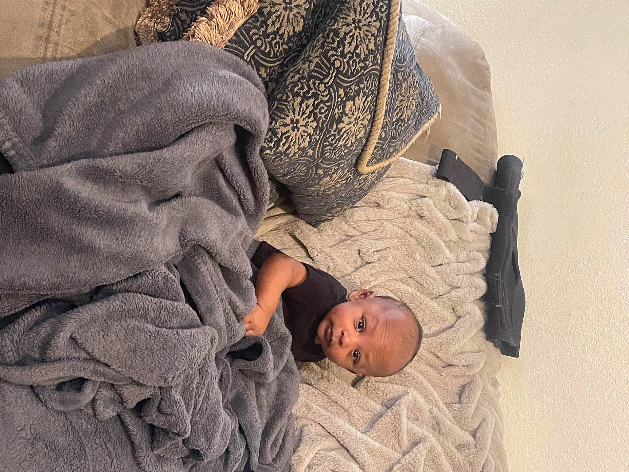 Josiah is registered to the contest to win money with this photo: baby, baby_sleeping, bed_sheet, bedding, bedtime, carpet, child, comfort, flooring, fur, linens, nap, pattern, person, room, sitting, sleep, sleeve, toddler, wood