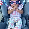 baby, child, sunglasses, pink, car_seat, cute, fashion, floral_pants, socks, portrait, infant, person, seat, clothing, young_child, comfort, cute_expression, indoor, accessory, adorable