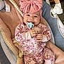 Leilei joined the competition — help win amazing prizes! baby, infant, pacifier, pink_bow, onesie, floral_pattern, blanket, baby_rocker, plush_toy, smile, happy, indoors, child, cute, headband, soft_toys, cozy, lying_down, clothing, comfort