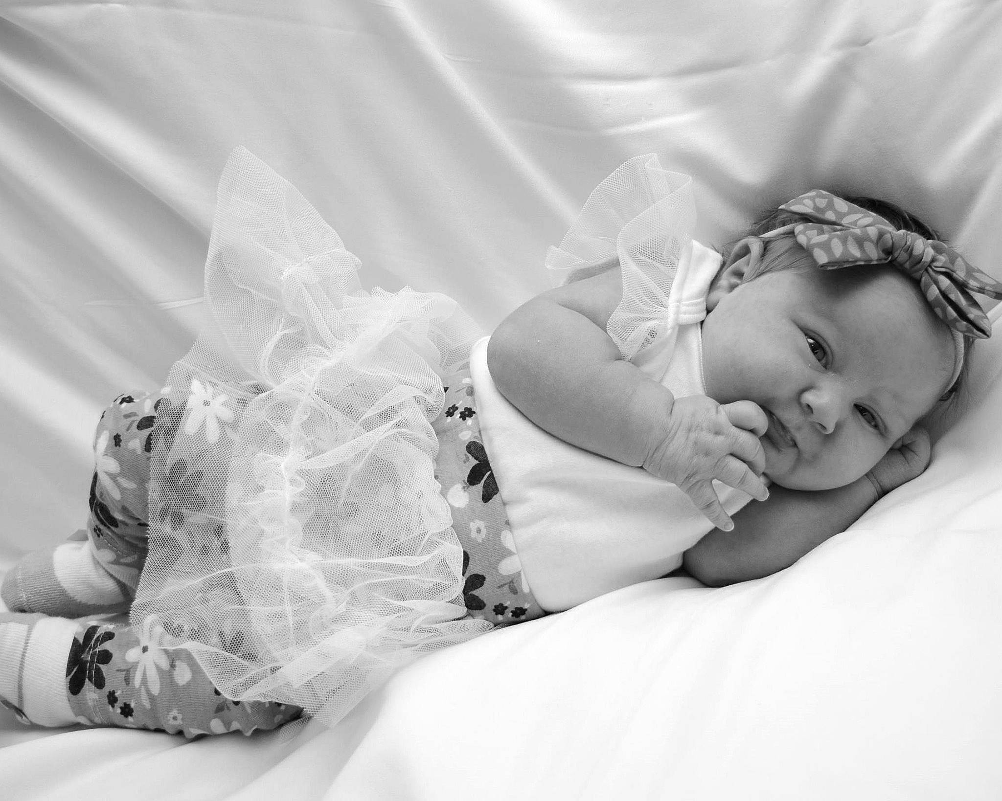 Alyvia is registered to the contest to win money with this photo: baby, bedding, bedtime, black_and_white, child, comfort, flash_photography, grass, happy, headband, headpiece, headwear, jewellery, linens, monochrome, monochrome_photography, person, portrait_photography, sitting, sleep