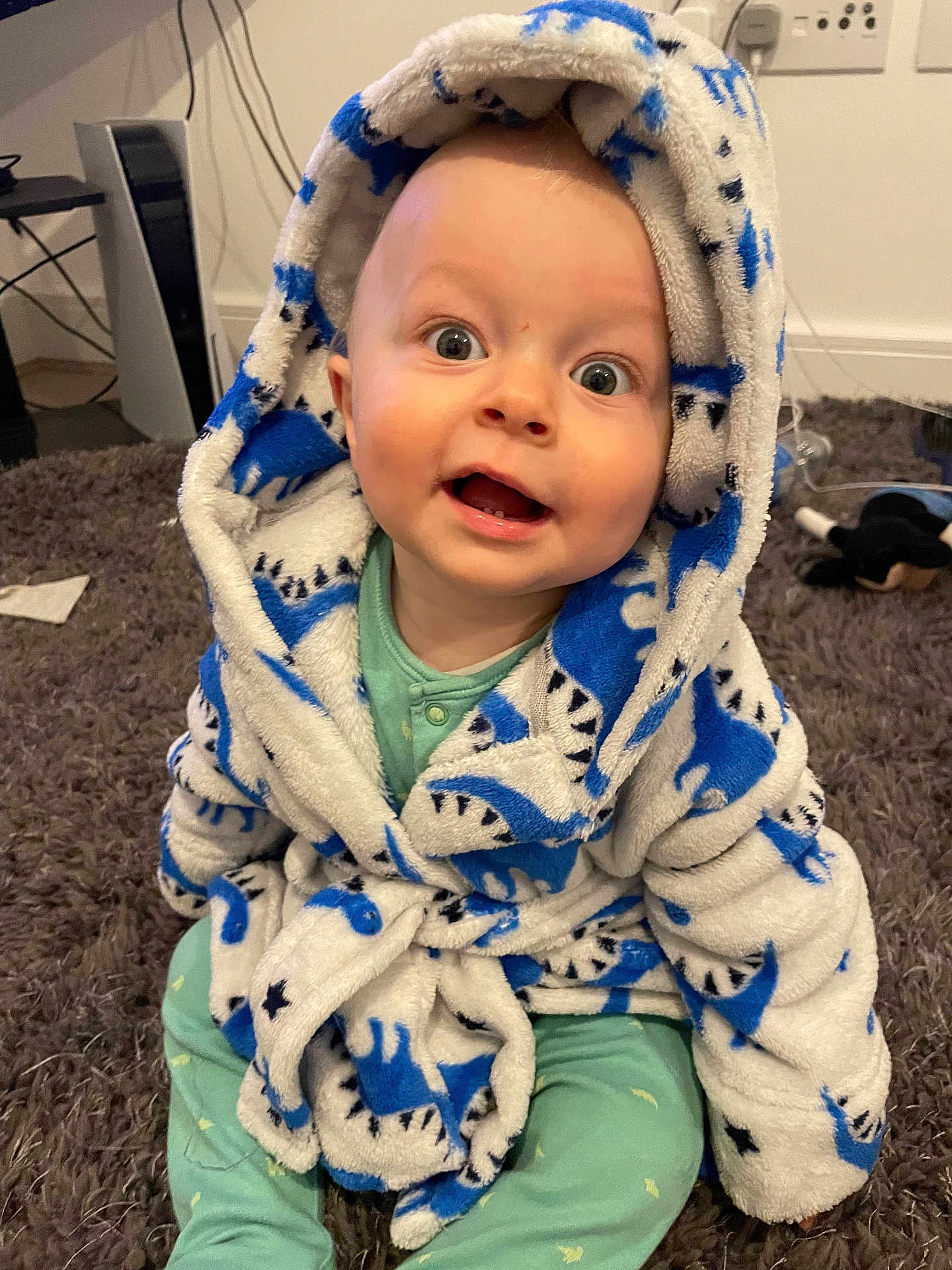 Carter joined the competition — help win amazing prizes! baby, child, bathrobe, blue, white, shark_pattern, carpet, indoor, cute, smiling, happy, sitting, cozy, plush, face, expression, hooded, clothing, infant, playful