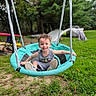 Ezra joined the competition — help win amazing prizes! child, toddler, smiling, happy, outdoor, backyard, swing, playground, basketball_hoop, grass, trees, garden, toy, playtime, sitting, gray_shirt, sneakers, portrait, family, summer