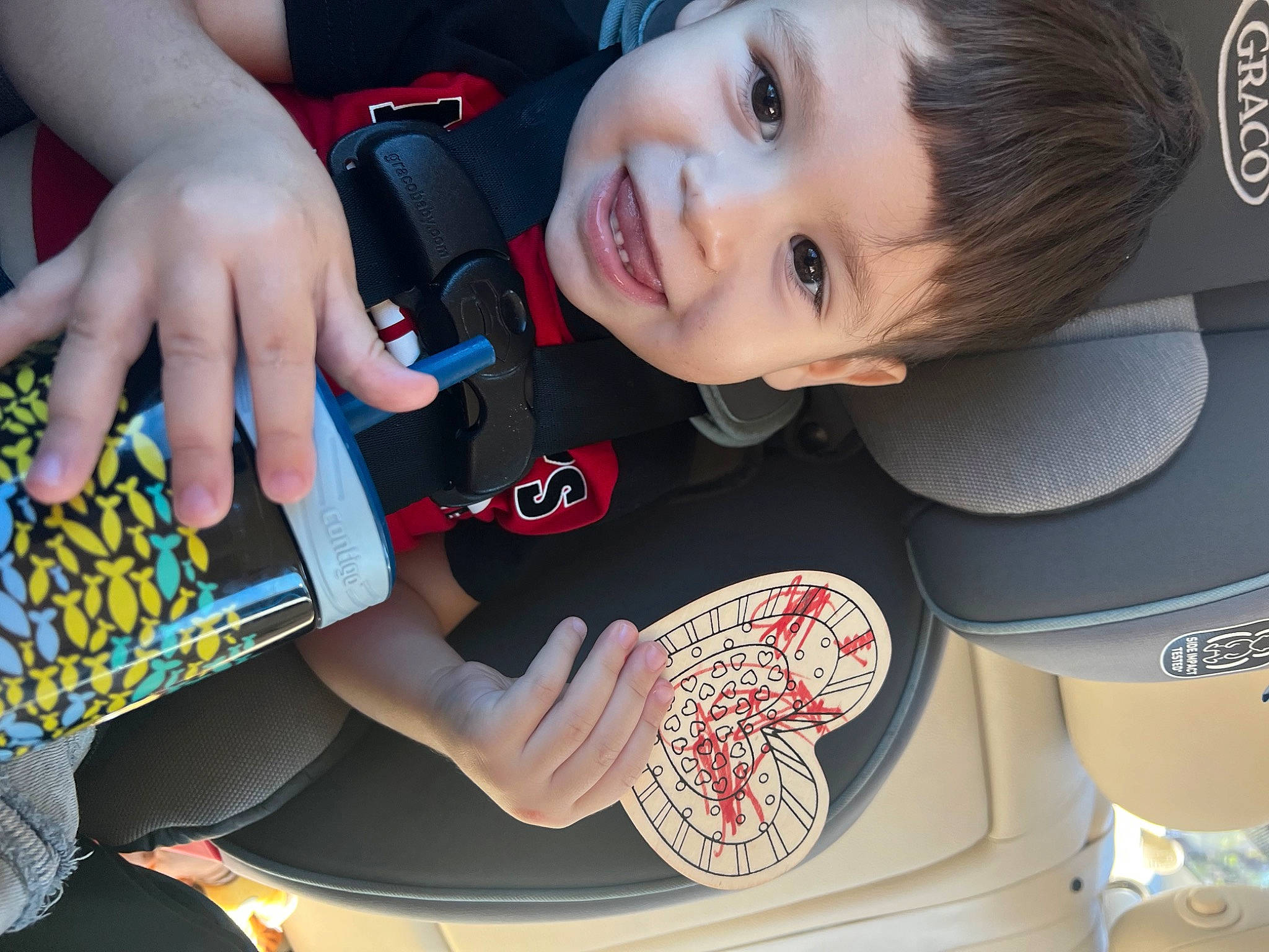 Angelo joined the competition — help win amazing prizes! auto_part, automotive_design, automotive_exterior, automotive_wheel_system, baby_toddler_clothing, car_seat, car_seat_cover, child, electric_blue, facial_expression, gesture, hand, happy, joy, motor_vehicle, person, product, smile, steering_part, steering_wheel