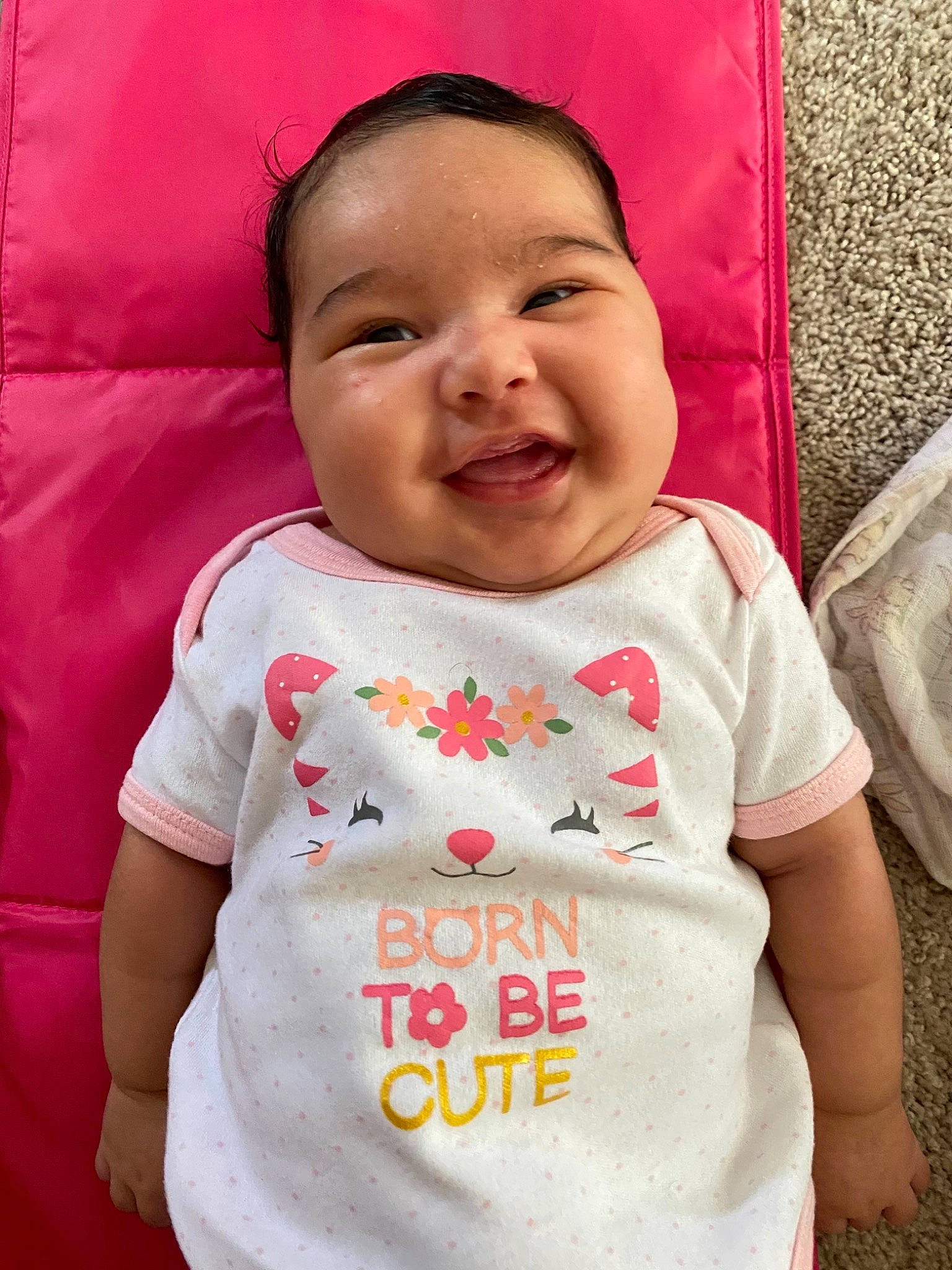 Karma is registered to the contest to win money with this photo: baby, baby_toddler_clothing, cheek, child, cool, dress, face, facial_expression, happy, human, lip, person, pink, product, red, skin, sleeve, smile, t_shirt, textile