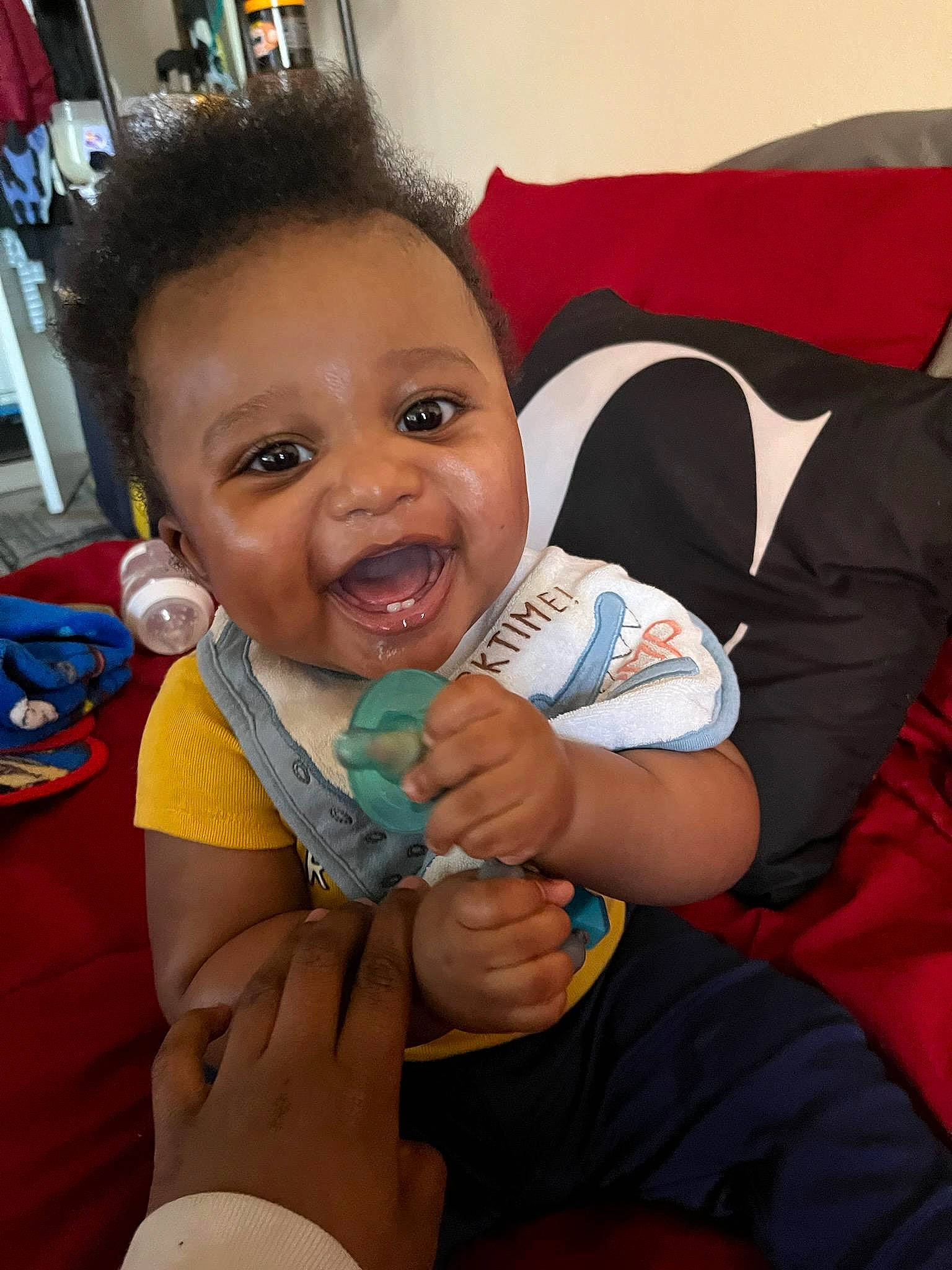 Marcel is registered to the contest to win money with this photo: baby, baby_toddler_clothing, cheek, child, comfort, eye, finger, fun, gesture, hairstyle, hand, happy, head, lap, mouth, nose, person, skin, smile, thumb