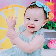 Sophia joined the competition — help win amazing prizes! baby, child, smiling, blue_bow, blue_dress, waving_hands, lemon_slice, pink_background, plant, flower, cute, indoors, portrait, happy, sitting, headband, colorful, decor, cheerful, playful