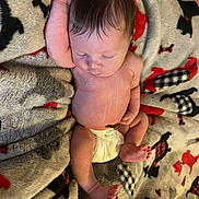 Natalie is registered to the contest to win money with this photo: baby, newborn, infant, sleeping, diaper, blanket, pattern, soft, cute, peaceful, skin, arm, foot, hand, lying_down, indoors, rest, child, young, cozy