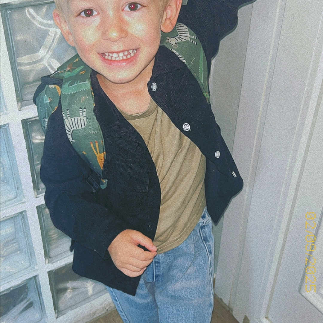 Nëlyo a rejoint le concours — aidez-le/la à gagner de superbes lots ! backpack, boy, casual_clothing, child, door, footwear, glass_blocks, happy, indoor, jacket, jeans, light_skin, portrait, posing, short_hair, smile, standing, white_shoes, wooden_floor, young