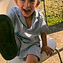 child, boy, smiling, hat, cap, chair, outdoor, sunlight, happy, foot, playful, summer, clothing, grass, concrete, person, casual, daylight, young, fun