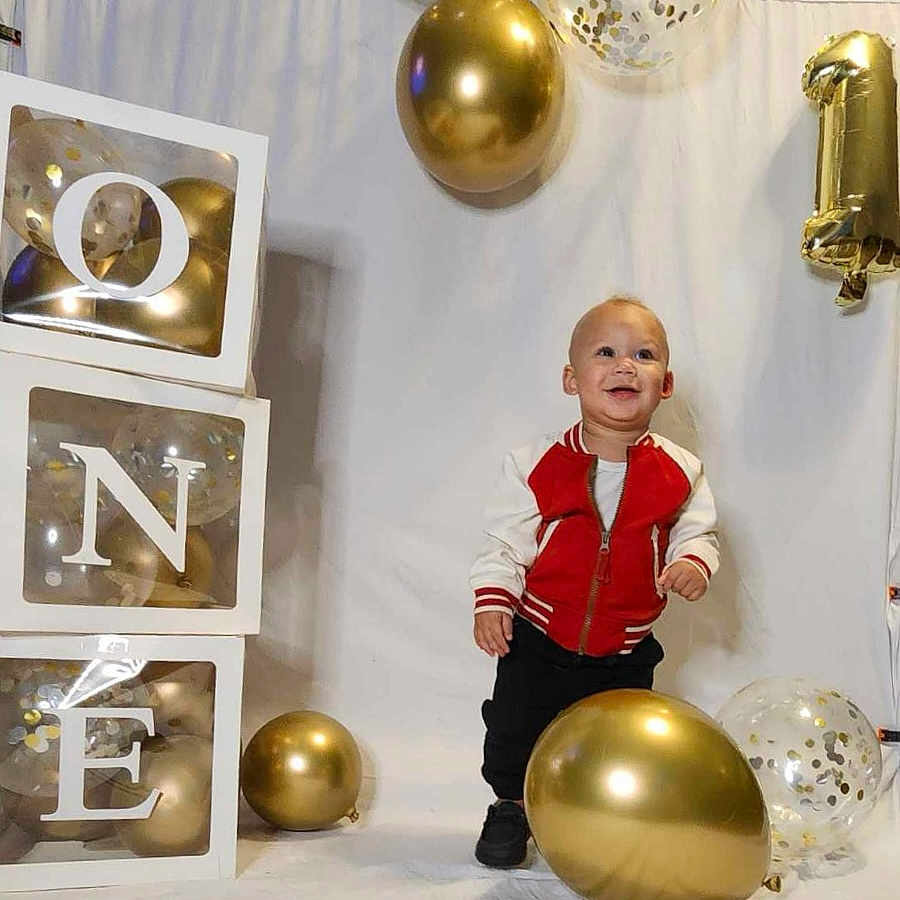 Zamir joined the competition — help win amazing prizes! balloon, blonde, boy, child, clothing, coat, face, festival, hair, head, jacket, male, number, pants, people, person, sitting, sleeve, symbol, text