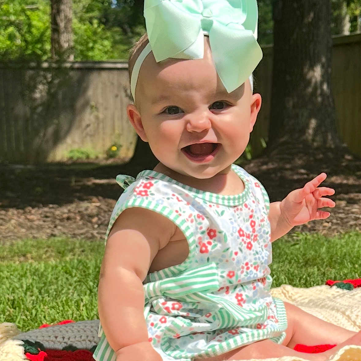 Laci Joy joined the competition — help win amazing prizes! baby, blanket, bow, child, crochet, cute, dress, fence, garden, grass, happy, headband, infant, outdoor, person, sitting, smiling, summer, sunlight, tree