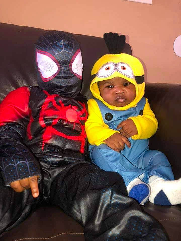 Jayceon is registered to the contest to win money with this photo: boot, cap, carmine, child, cool, costume, couch, event, eye, fictional_character, fun, headgear, headwear, lap, mask, masque, person, personal_protective_equipment, purple, room