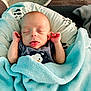 baby, infant, blanket, sleeping, tongue_out, hands, cushion, soft, cozy, cute, indoors, clothing, fabric, comfort, rest, person, newborn, peaceful, wrapped, head