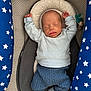 baby, newborn, sleeping, infant, clothing, blue, striped, baby_seat, cushion, pacifier, stars, pattern, sock, head, face, arms_up, cozy, sleep, indoor, child