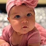 Alaia joined the competition — help win amazing prizes! baby, infant, pink_bow, headband, pink_clothing, lying_down, chubby_cheeks, wide_eyes, soft_focus, indoor, cute, child, portrait, close_up, skin, hand, expression, adorable, toddler, face