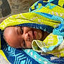 baby, child, towel, smile, face, head, wrapped, colorful, patterned, texture, happy, indoors, closeup, infant, cute, joyful, skin, person, portrait, cozy