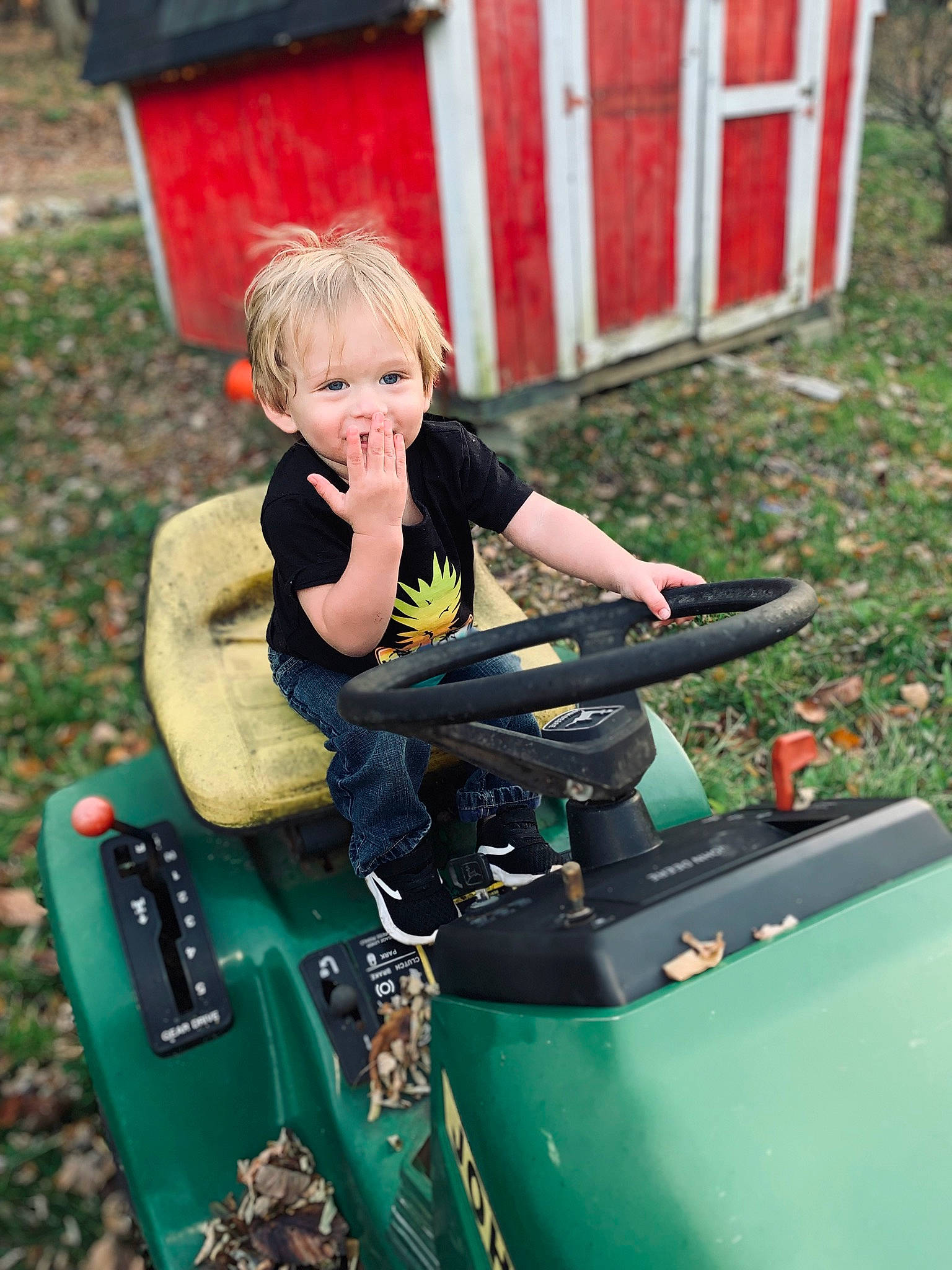 Jeremiah Josiah is registered to the contest to win money with this photo: automotive_exterior, automotive_tire, bumper, fun, grass, green, leisure, machine, motor_vehicle, people_in_nature, person, plant, play, recreation, sitting, soil, toy, toy_vehicle, tractor, tree