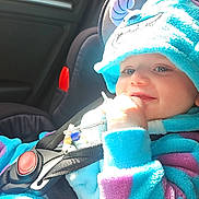 Alfie joined the competition — help win amazing prizes! baby, child, car_seat, car_interior, blue_clothing, purple_clothing, plush_outfit, toy, seatbelt, smiling, happy, face, hand, window, sunlight, cute, infant, safety, portrait, indoor