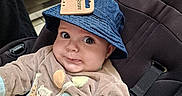 Pierre a rejoint le concours — aidez-le/la à gagner de superbes lots ! baby, hat, blue_hat, car_seat, clothing, baby_clothes, price_tag, store, shopping, child, infant, cute, wide_eyes, curious, mischievous, seated, indoor, fabric, person, retail