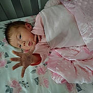 Scarlett joined the competition — help win amazing prizes! baby, infant, child, hand, pink_blanket, pink_clothing, bed, floral_sheet, face, reaching_hand, sleepwear, blanket, skin, person, newborn, lying_down, closeup, cute, soft_texture, indoor