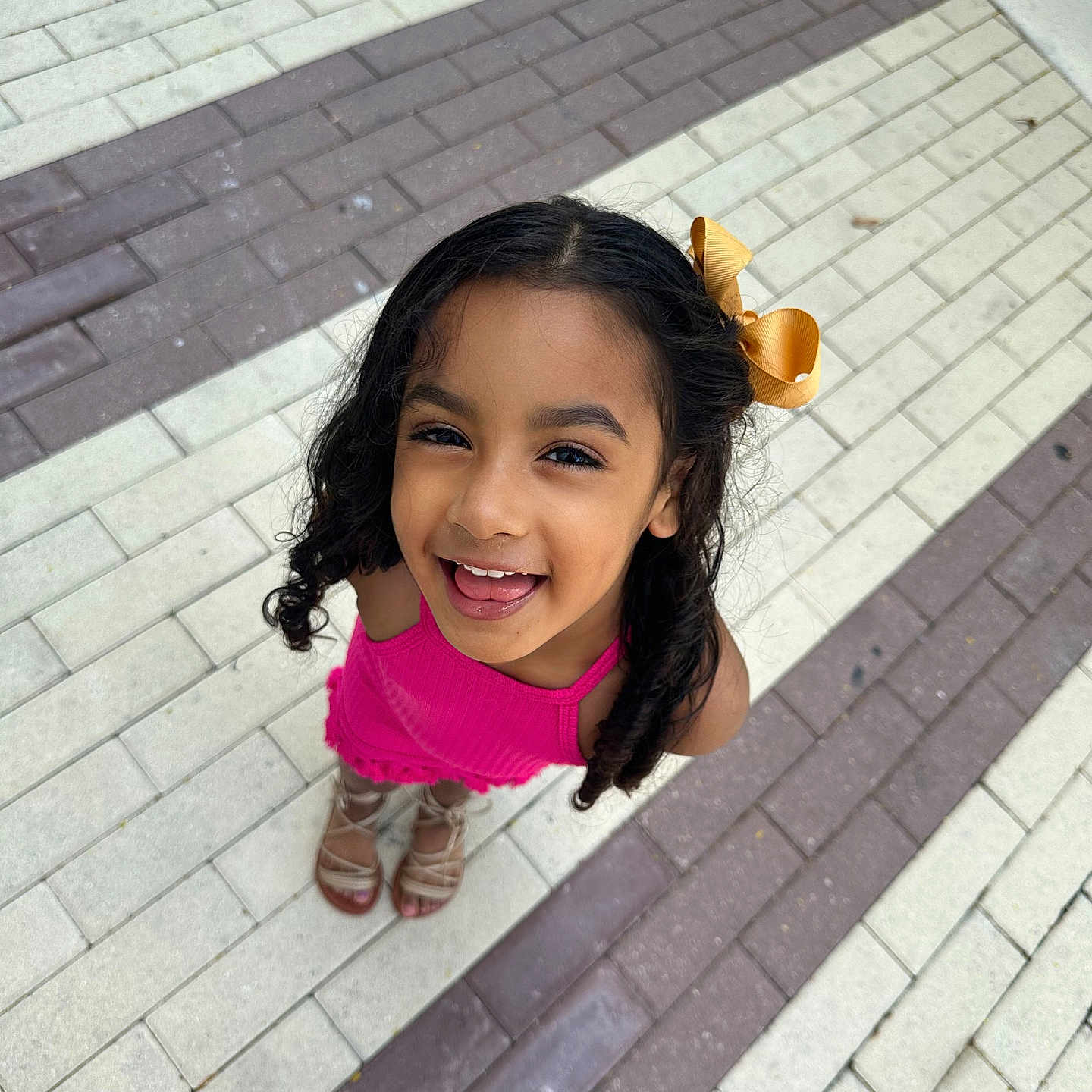 Gianni is registered to the contest to win money with this photo: brick, child, city, clothing, face, female, footwear, girl, happy, head, pants, path, person, photography, portrait, road, sidewalk, smile, street, urban