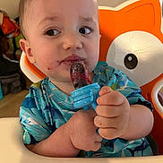 Rhyker is registered to the contest to win money with this photo: baby, bodypart, couch, cream, cutlery, dessert, eating, face, finger, food, hand, head, icecream, icing, person, photography, portrait, sitting, spoon, sweets