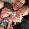 Mariska is registered to the contest to win money with this photo: adult, boy, casual, child, closeup, clothing, couch, face, family, girl, glasses, happy, holding, home, indoor, person, portrait, smiling, toddler, together