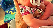 Mariska is registered to the contest to win money with this photo: adult, baby, blanket, bracelet, care, child, closeup, clothing, colorful, comfort, family, furniture, hand, indoor, infant, newborn, pacifier, sleeping, tattoo, tenderness