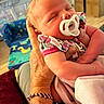 adult, baby, blanket, bracelet, care, child, closeup, clothing, colorful, comfort, family, furniture, hand, indoor, infant, newborn, pacifier, sleeping, tattoo, tenderness