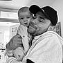 Delilah May is registered to the contest to win money with this photo: adult, appliance, baby, baseballcap, cap, clothing, device, electricaldevice, face, hat, head, kissing, male, man, newborn, person, photography, portrait, romantic, washer
