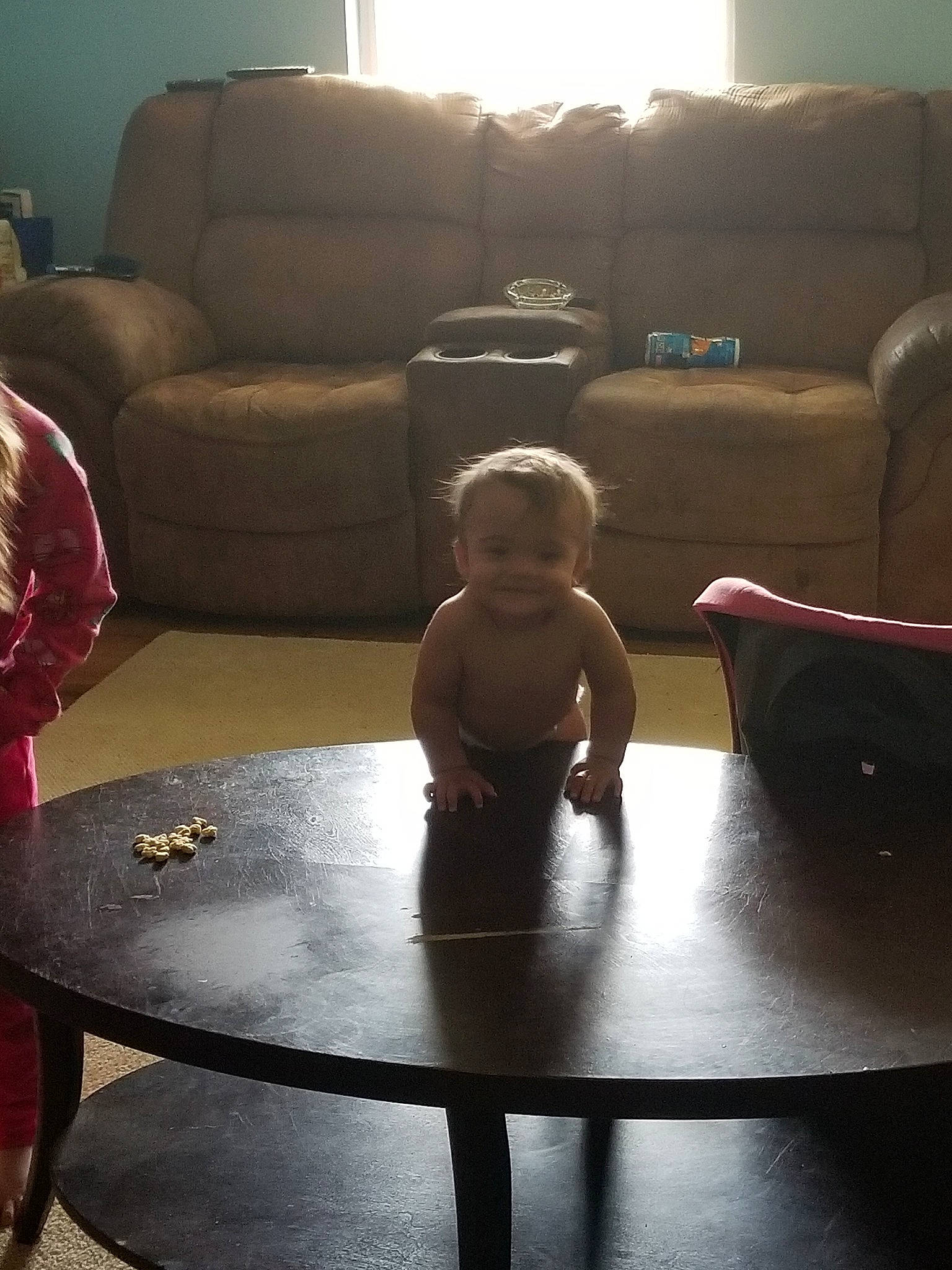 Cara is registered to the contest to win money with this photo: chair, child, coffee_table, comfort, couch, floor, flooring, furniture, hardwood, interior_design, joy, leg, living_room, person, room, sitting, table, toddler