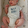 baby, bed, child, comfortable, cushion, cute, expression, face, happy, indoors, infant, lying_down, newborn, onesie, pattern, skin, sleeping_area, small, smiling, soft